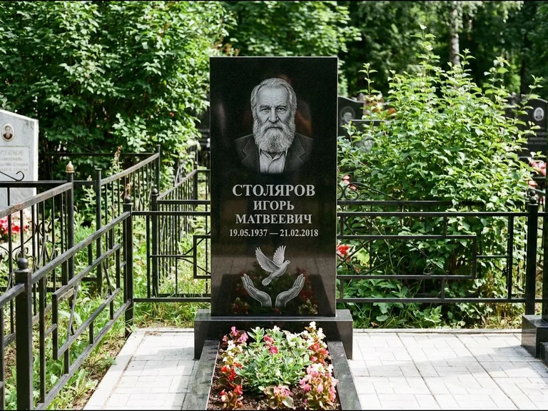 Памятник с гравировкой голубей — гравировка голубя над раскрытыми ладонями внизу стелы, работа «Столяров» в Якутске