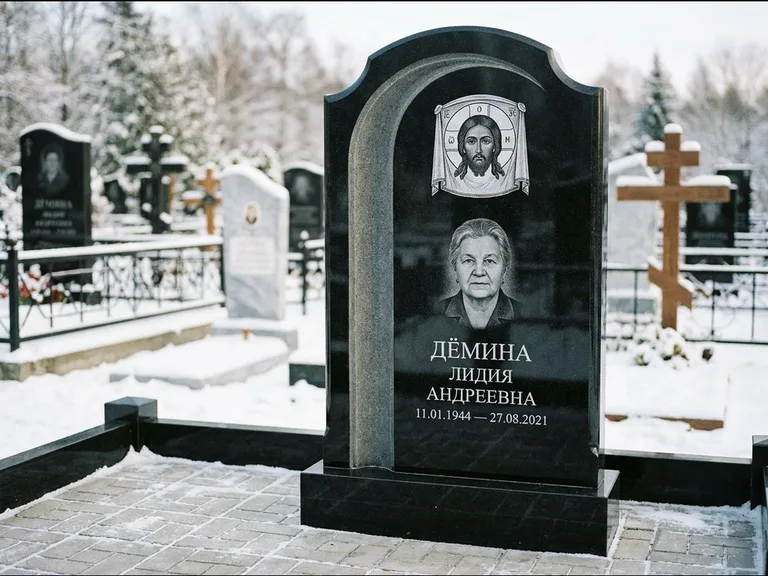 Памятник с гравировкой иконы: гранёный восьмиугольный обелиск с крестом — гравировка Николая Чудотворца, семейный участок с гранитной скамьёй, работа «Зотов» в Якутске