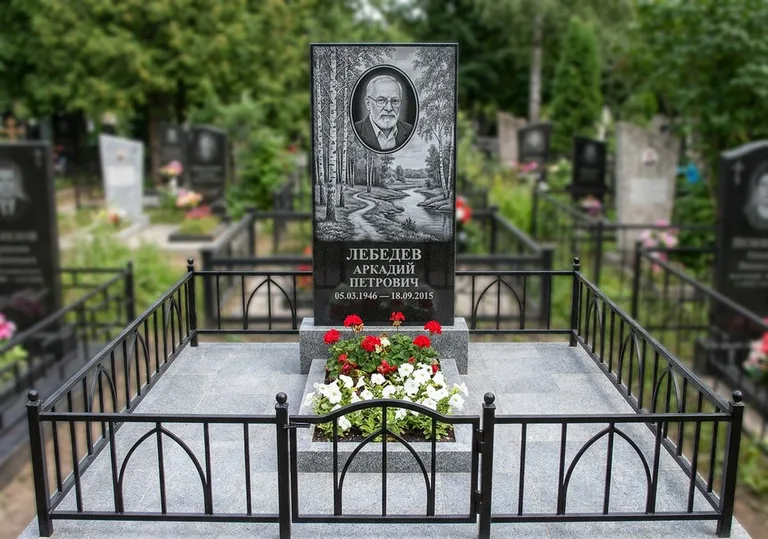 Памятник с гравировкой берёзовой рощи, портретом и надписью в Якутске